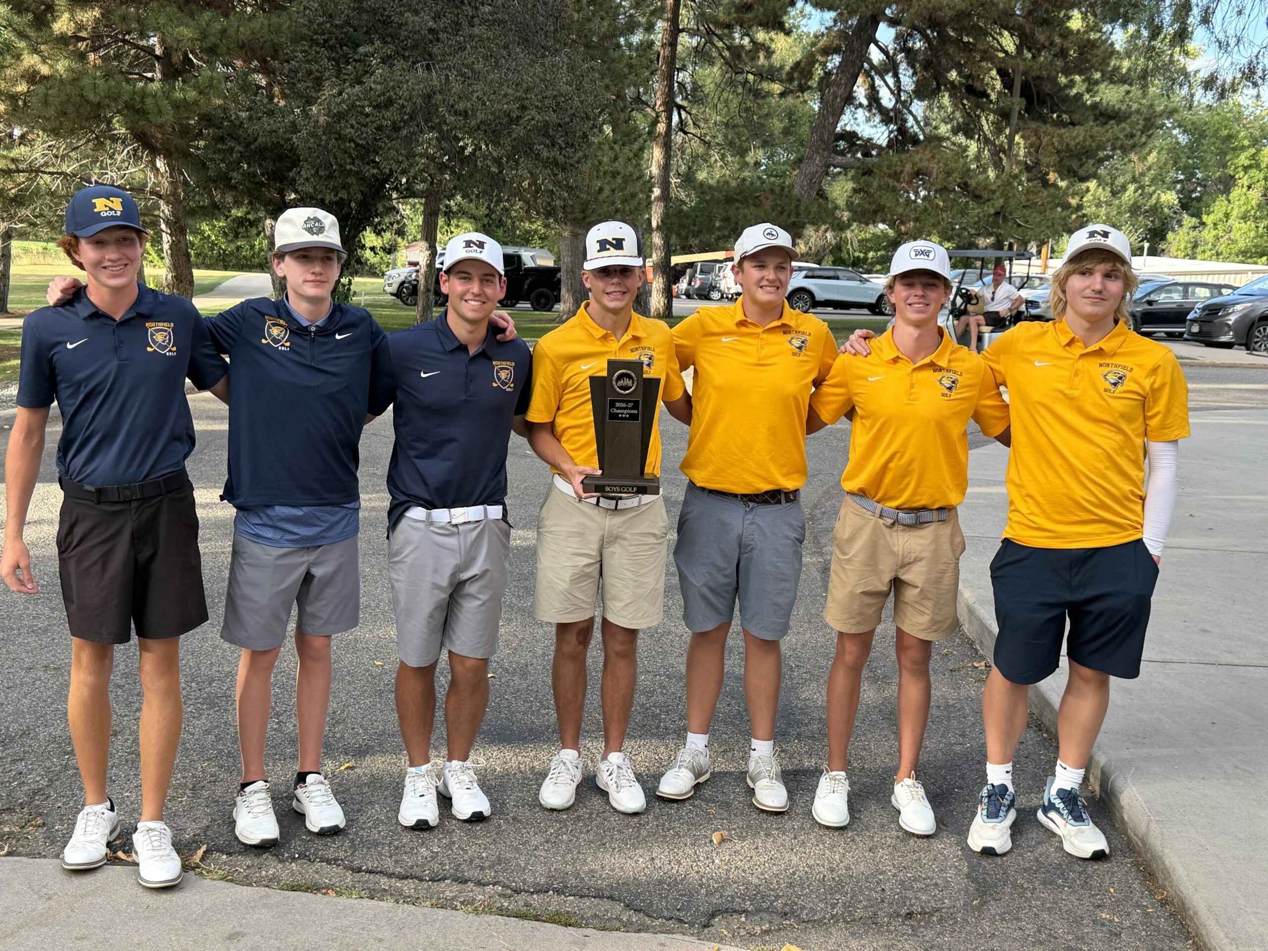 Seven players arms over shoulders. Owen Parsley, Ryder Hladik, James Henderson, Reyce Wicks, Owen Fauerbach, Jake Carr, Nicholas Johnson