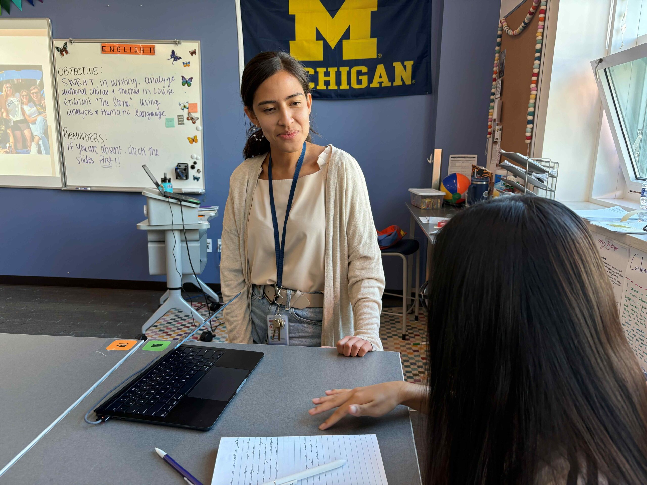 Teacher speaking to student in classroom one to one
