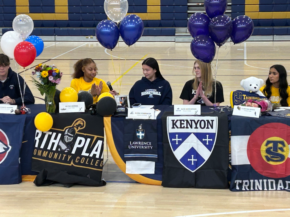 student-athletes passing the mic as they present for signing day
