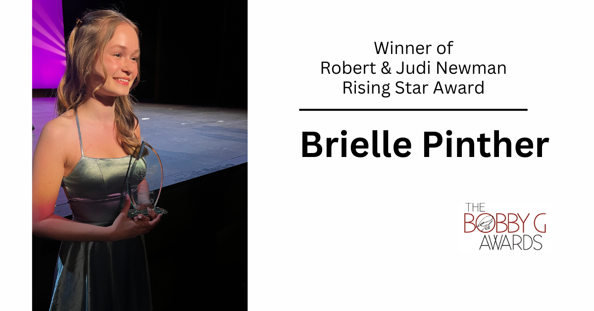 Brielle holding her award