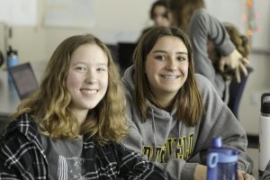 Two students smiling